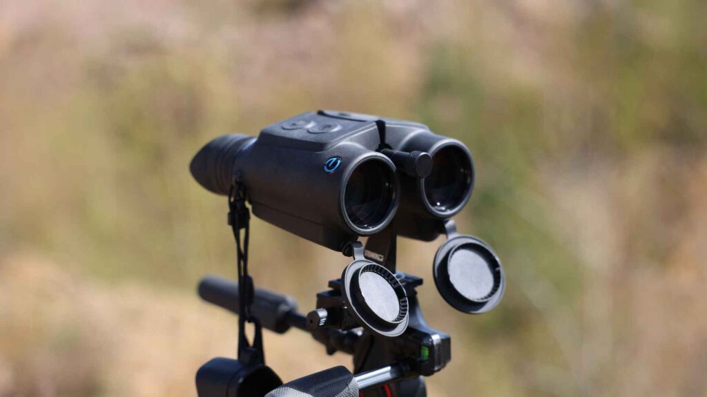 Steiner eDiscovery 10x42 Fernglas auf Stativ mit geöffneten Objektivdeckeln, Seitenansicht im hellen Tageslicht.